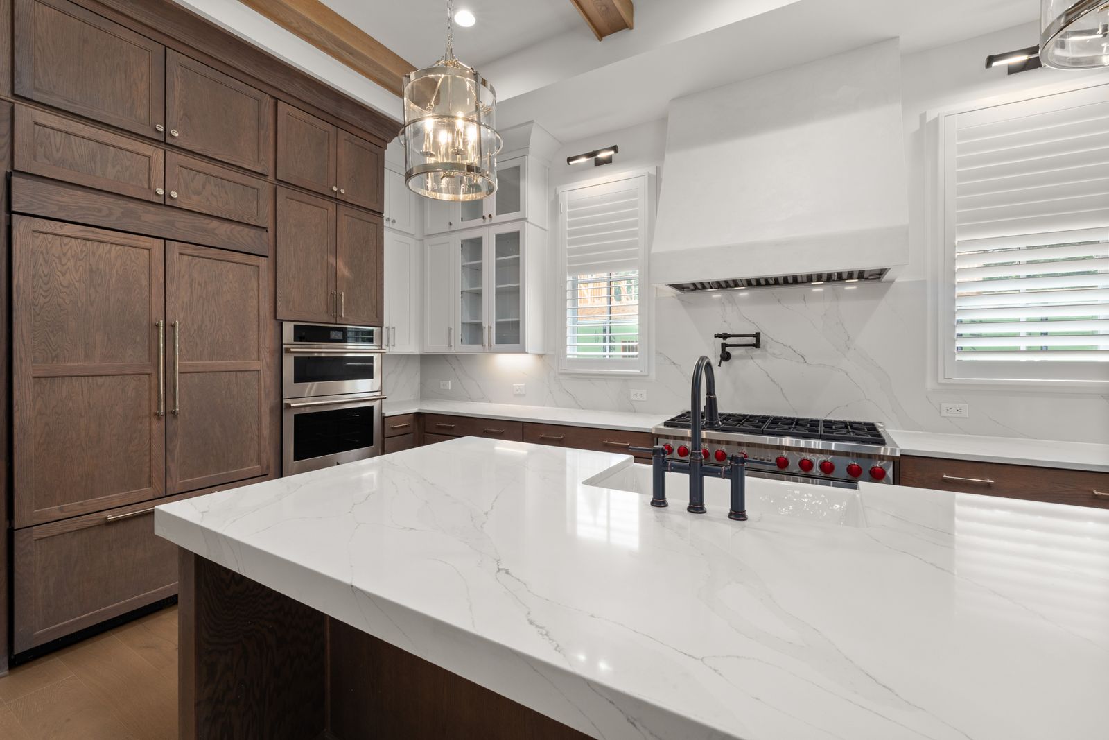 Cherry inset cabinetry and stone counters in a farmhouse kitchen