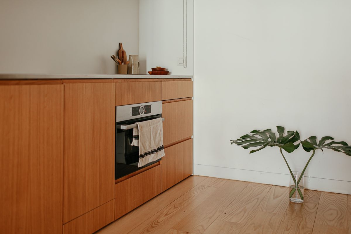 Tall painted built-in cabinetry beside a window