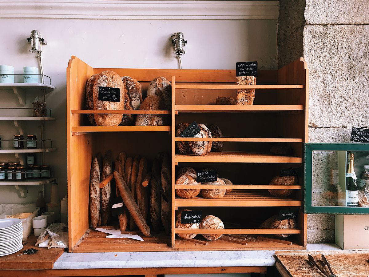Bread on the wooden shelves behind the counter